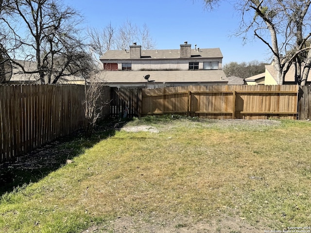 view of yard with a fenced backyard