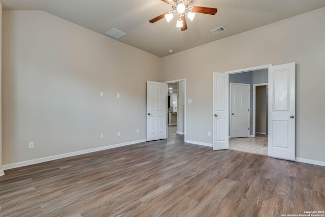 unfurnished bedroom featuring wood finished floors, visible vents, and baseboards