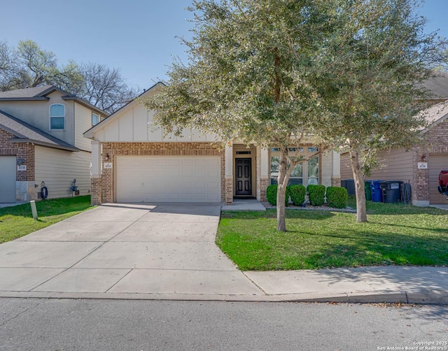 view of front of home featuring brick siding, a garage, driveway, and a front lawn