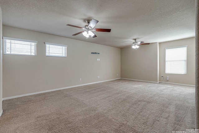 empty room featuring light carpet, plenty of natural light, and ceiling fan