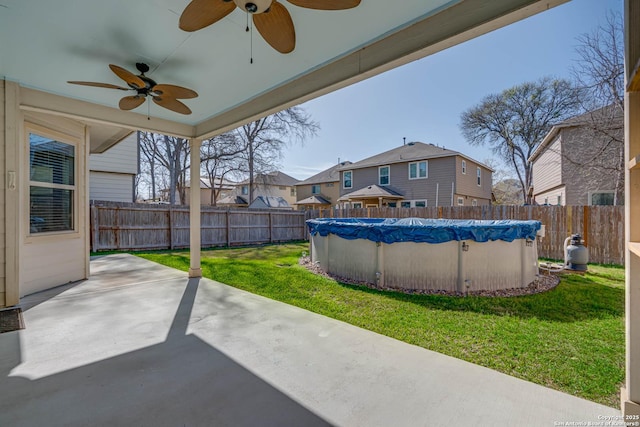 view of patio / terrace with ceiling fan, a fenced in pool, a residential view, and a fenced backyard