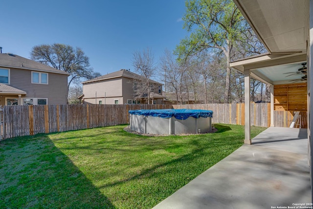 view of yard featuring ceiling fan, a fenced in pool, a patio, and fence private yard