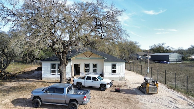 view of front of home featuring fence