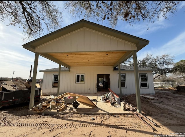 back of house with an outdoor fire pit, a patio, and fence