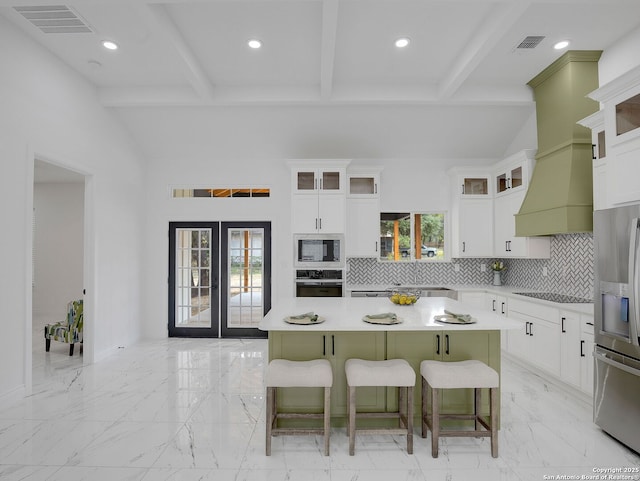 kitchen with visible vents, marble finish floor, stainless steel appliances, and a breakfast bar area