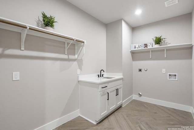 laundry room with hookup for a washing machine, visible vents, laundry area, a sink, and electric dryer hookup