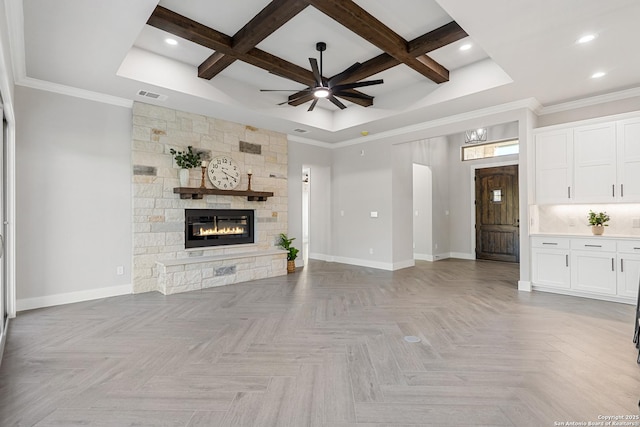 unfurnished living room featuring a stone fireplace, coffered ceiling, baseboards, and ceiling fan