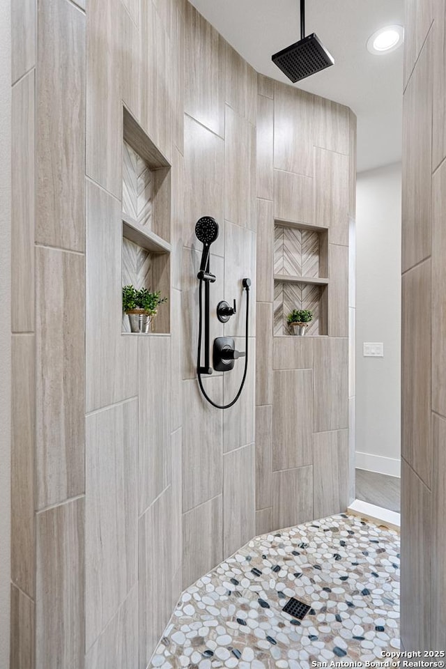 bathroom with tiled shower