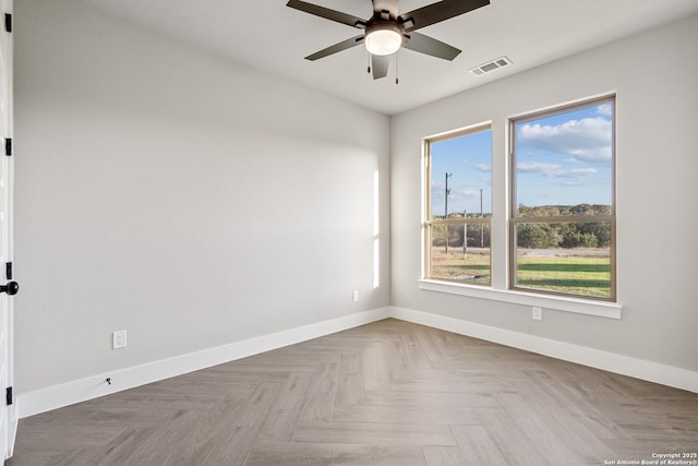 spare room featuring visible vents, baseboards, and ceiling fan