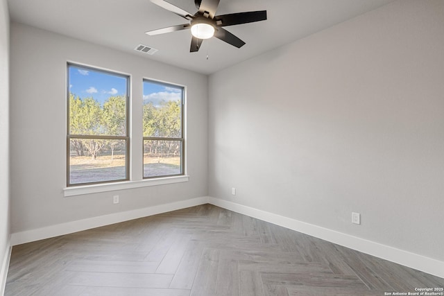 empty room featuring visible vents, baseboards, and a ceiling fan