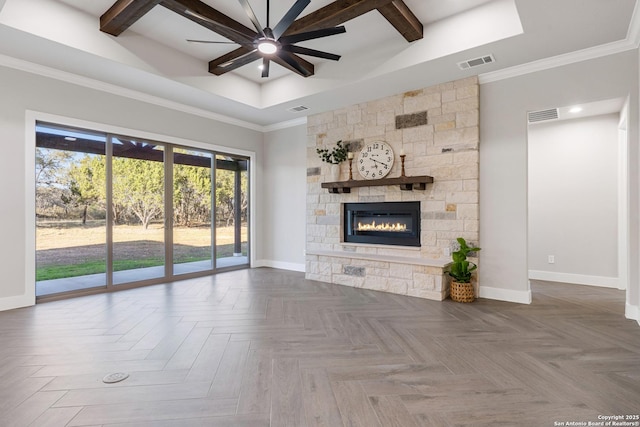 unfurnished living room featuring visible vents, baseboards, a stone fireplace, and a ceiling fan