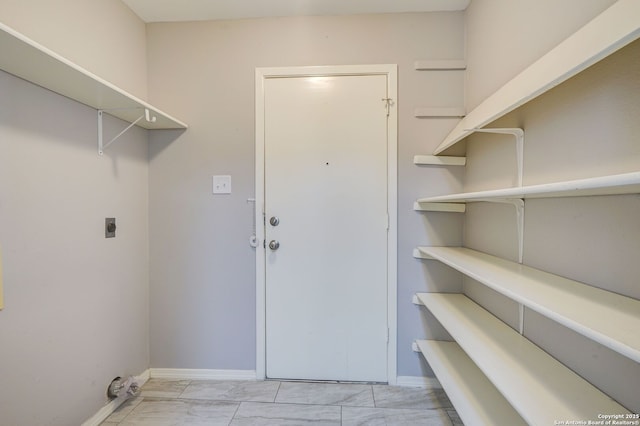 washroom featuring laundry area, baseboards, marble finish floor, and electric dryer hookup