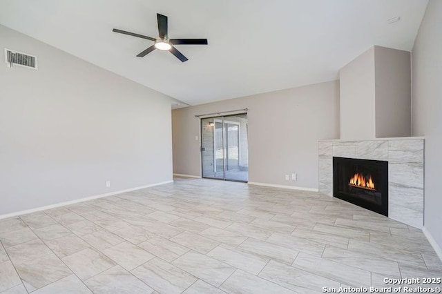 unfurnished living room with visible vents, a ceiling fan, a fireplace, baseboards, and vaulted ceiling