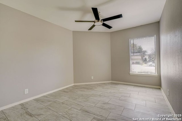 unfurnished room featuring baseboards and ceiling fan