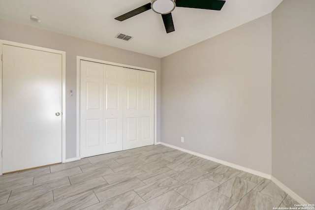 unfurnished bedroom with baseboards, visible vents, a closet, and ceiling fan