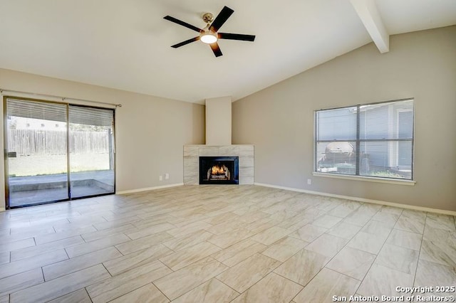 unfurnished living room featuring baseboards, vaulted ceiling with beams, a ceiling fan, and a tiled fireplace