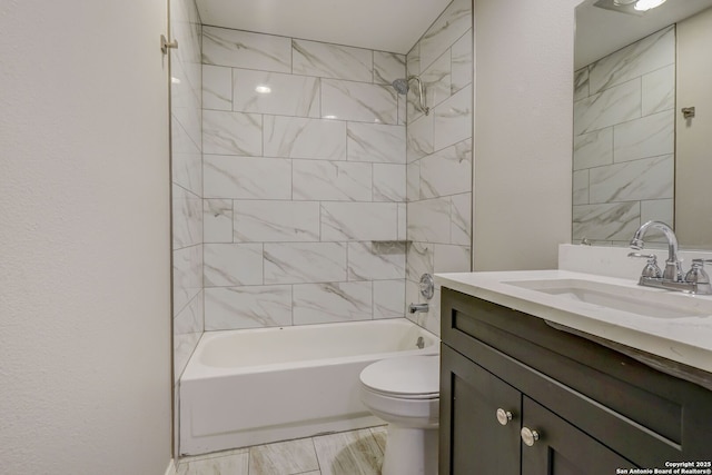 bathroom with toilet, vanity, and bathing tub / shower combination