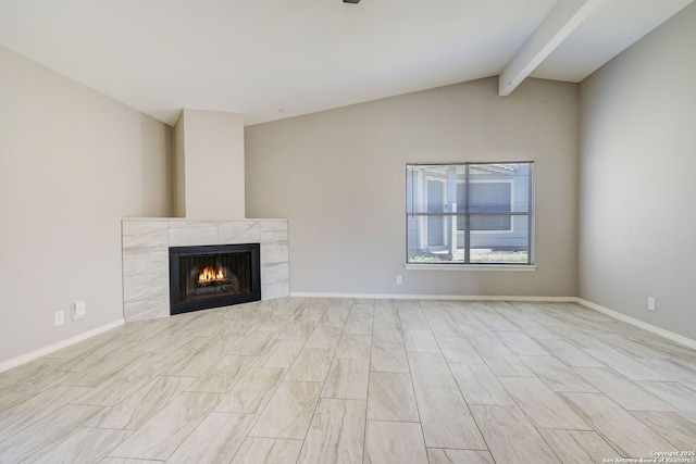 unfurnished living room featuring a fireplace, lofted ceiling with beams, and baseboards