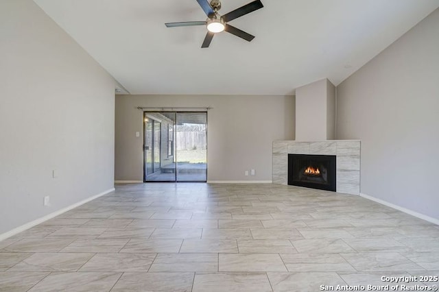 unfurnished living room with baseboards, a fireplace, and a ceiling fan