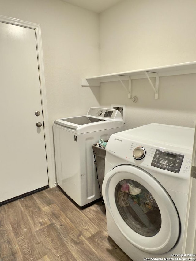 laundry area with laundry area, wood finished floors, and separate washer and dryer