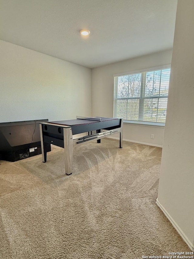 rec room with carpet flooring and baseboards