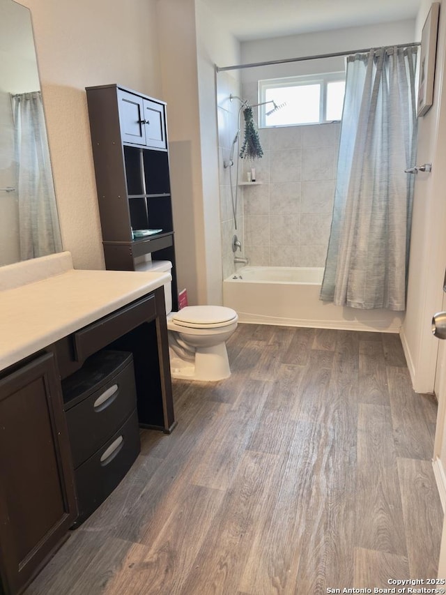 bathroom featuring vanity, toilet, shower / bath combo with shower curtain, and wood finished floors