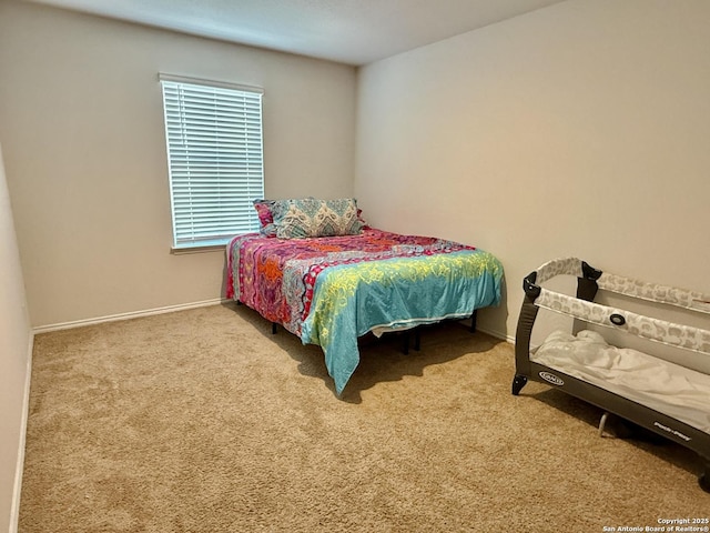 carpeted bedroom with baseboards