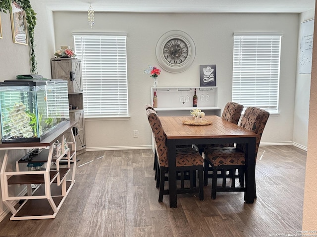 dining room featuring wood finished floors and baseboards