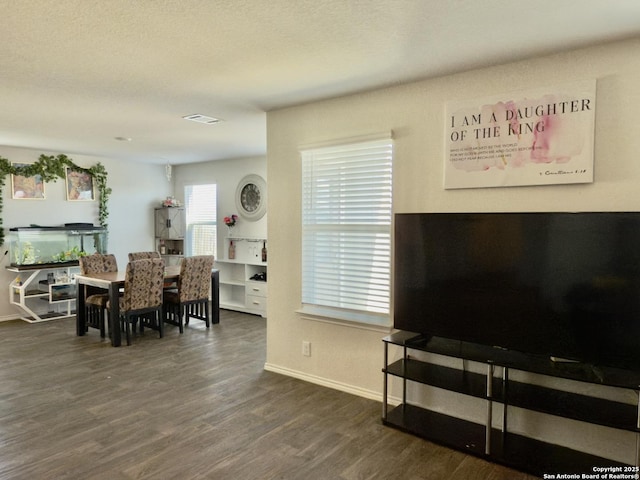 interior space featuring baseboards and dark wood-style floors