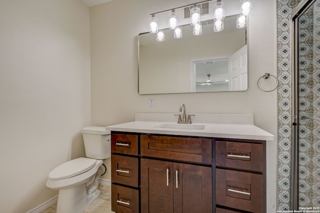 bathroom featuring vanity, toilet, baseboards, and ceiling fan