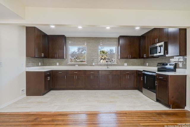 kitchen featuring a sink, appliances with stainless steel finishes, and light countertops