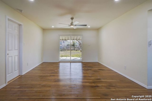 unfurnished room featuring wood finished floors, baseboards, and ceiling fan