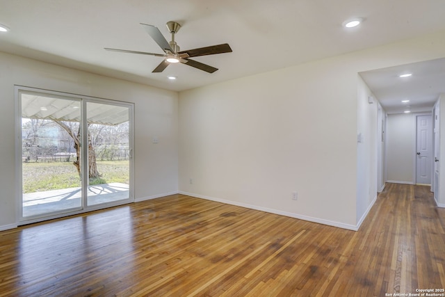 empty room featuring recessed lighting, a ceiling fan, baseboards, and hardwood / wood-style flooring