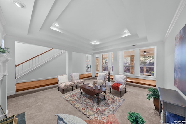 living area featuring baseboards, stairway, a tray ceiling, ornamental molding, and recessed lighting