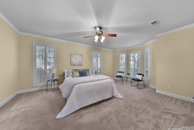 carpeted bedroom with visible vents, baseboards, ceiling fan, and crown molding