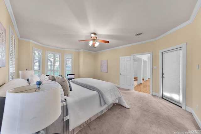 bedroom featuring carpet flooring, baseboards, visible vents, and ornamental molding