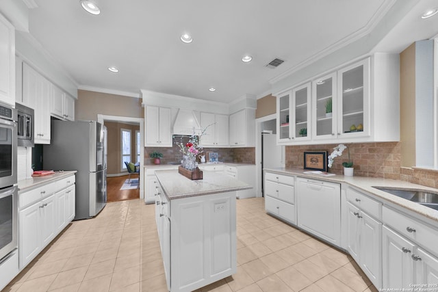 kitchen with white cabinetry, crown molding, visible vents, and appliances with stainless steel finishes