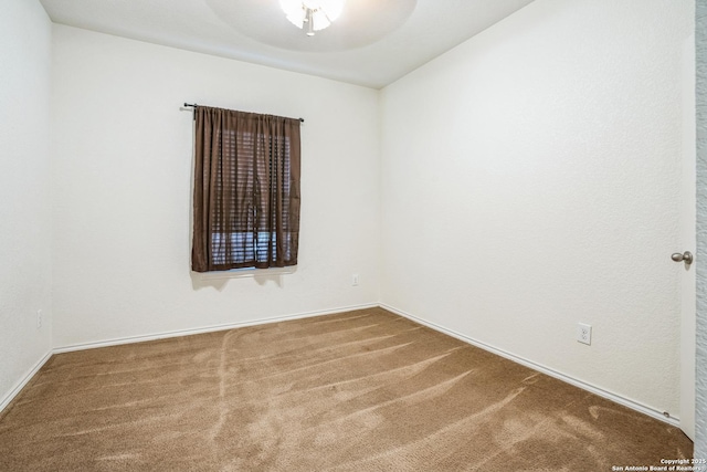 carpeted spare room with baseboards