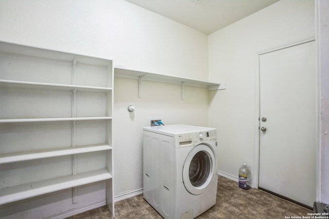 laundry area with laundry area, washer / clothes dryer, and baseboards