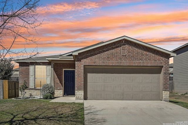 view of front of home featuring brick siding, driveway, a garage, and fence