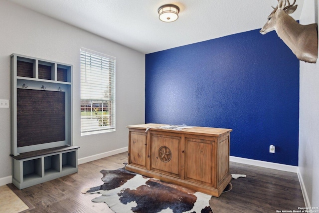 home office with baseboards and wood finished floors