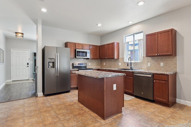 kitchen featuring a sink, a center island, tasteful backsplash, and stainless steel appliances