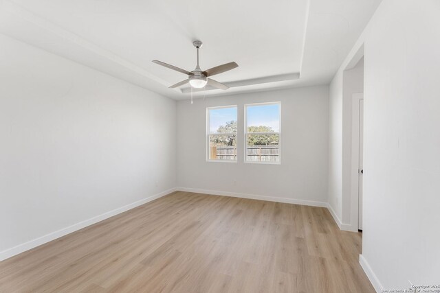 13223 Edith Gdns, San Antonio, TX 78253 - unfurnished room featuring light wood finished floors, baseboards, a raised ceiling, and a ceiling fan