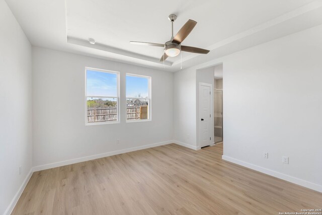 13223 Edith Gdns, San Antonio, TX 78253 - empty room with a raised ceiling, a ceiling fan, baseboards, and light wood-type flooring