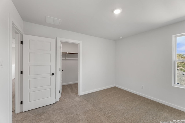 13223 Edith Gdns, San Antonio, TX 78253 - unfurnished bedroom featuring a spacious closet, light colored carpet, visible vents, and baseboards