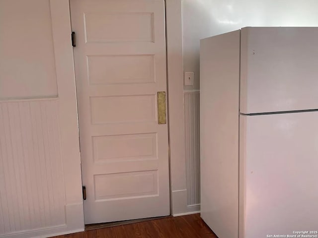 interior space featuring dark wood-style floors and freestanding refrigerator