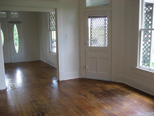 foyer entrance featuring baseboards and wood-type flooring