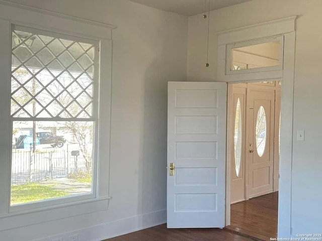 entrance foyer featuring baseboards and dark wood-style flooring