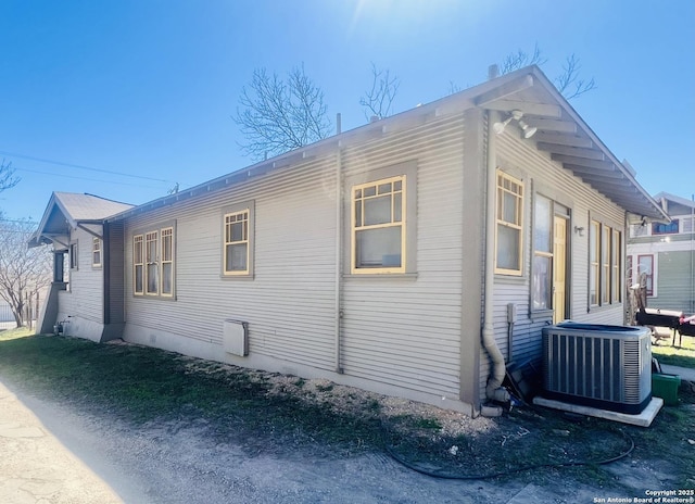 view of side of property with central AC unit