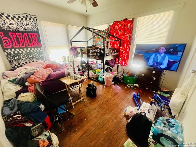 bedroom with wood-type flooring and a ceiling fan